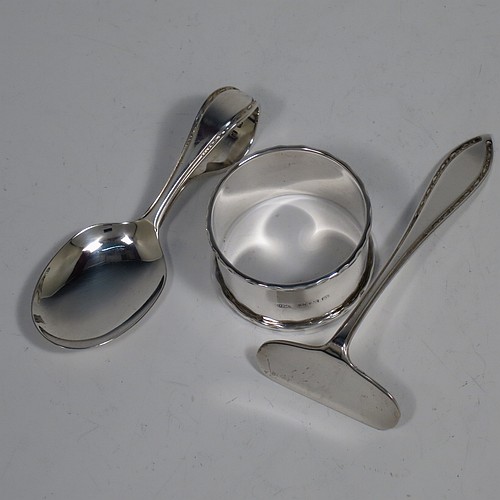 A Sterling Silver pusher, spoon, and napkin christening set, having a plain style with oval bowl, a plain pusher, and a napkin ring, all with egg and dart borders, and all sitting in their original cream satin and back velvet-lined presentation box. Made by the Arthur Price and Co. Ltd., of Birmingham in 1938. The dimensions of this fine hand-made silver christening set are length of spoon 9 cms (3.5 inches), diameter of napkin ring 4.5 cms (1.75 inches), and the total weight is approx. 53g (1.7 troy ounces).