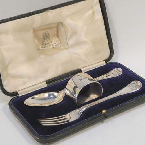 A very handsome Antique Sterling Silver christening set consisting of a plain round napkin ring, a spoon and fork in the double-struck Old English, Thread and Shell pattern, and all in their original cream satin and dark blue velvet-lined presentation box. This elegant silver christening set was mad by Martin Hall and Co., of Sheffield in 1912. The dimensions of this fine hand-made antique silver christening set are length of spoon and fork 16 cms (6.3 inches), diameter of napkin ring 4.5 cms (1.75 inches), and it has a total weight of approx. 124g (4 troy ounces).   