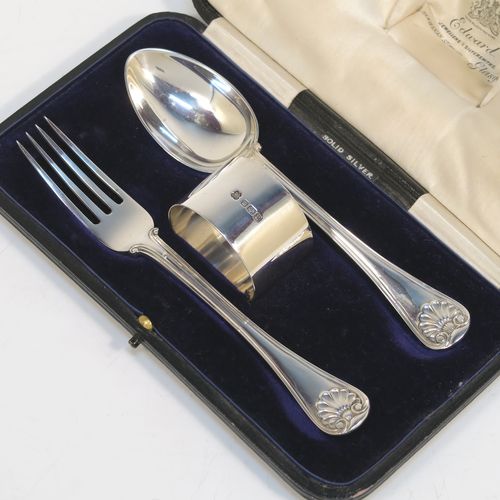 A very handsome Antique Sterling Silver christening set consisting of a plain round napkin ring, a spoon and fork in the double-struck Old English, Thread and Shell pattern, and all in their original cream satin and dark blue velvet-lined presentation box. This elegant silver christening set was mad by Martin Hall and Co., of Sheffield in 1912. The dimensions of this fine hand-made antique silver christening set are length of spoon and fork 16 cms (6.3 inches), diameter of napkin ring 4.5 cms (1.75 inches), and it has a total weight of approx. 124g (4 troy ounces).