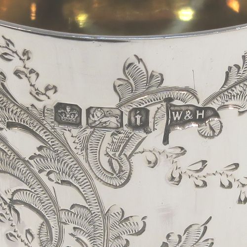 A very pretty Antique Victorian Sterling Silver christening set, consisting of a christening mug and spoon, all with hand-engraved floral decoration, and the mug with a gold-gilt interior, all sitting in an original dark and light blue satin and velvet-lined presentation box. Made by Walker and Hall of Sheffield in 1901. The dimensions of this fine hand-made antique silver christening set are length of spoon 13.5 cms (5.25 inches), height of mug 8 cms (3 inches), diameter at lip 6 cms (2.3 inches), and the total weight is approx. 175g (5.6 troy ounces).