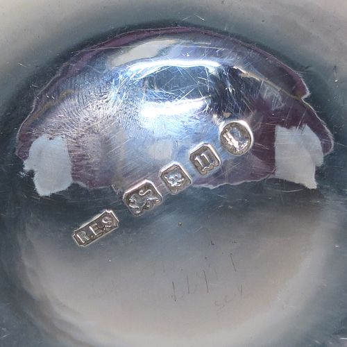 A beautiful Art Deco Sterling Silver christening set, consisting of a plain round bellied bowl with two cast side handles, and a plain spoon with matching hand-hammered decoration, all sitting in their original cream satin and black velvet-lined presentation box. This fantastic Art Deco silver bowl and spoon set was made by R. E. Stone of London in 1935. The dimensions of this fine hand-made silver christening set are length of spoon 14.5 cms (5.75 inches), diameter of bowl 11 cms (4.25 inches), and the total weight is approx. 226g (7.3 troy ounces).