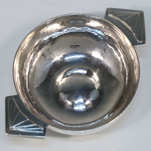 A beautiful Art Deco Sterling Silver christening set, consisting of a plain round bellied bowl with two cast side handles, and a plain spoon with matching hand-hammered decoration, all sitting in their original cream satin and black velvet-lined presentation box. This fantastic Art Deco silver bowl and spoon set was made by R. E. Stone of London in 1935. The dimensions of this fine hand-made silver christening set are length of spoon 14.5 cms (5.75 inches), diameter of bowl 11 cms (4.25 inches), and the total weight is approx. 226g (7.3 troy ounces).