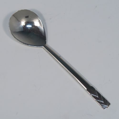 A beautiful Art Deco Sterling Silver christening set, consisting of a plain round bellied bowl with two cast side handles, and a plain spoon with matching hand-hammered decoration, all sitting in their original cream satin and black velvet-lined presentation box. This fantastic Art Deco silver bowl and spoon set was made by R. E. Stone of London in 1935. The dimensions of this fine hand-made silver christening set are length of spoon 14.5 cms (5.75 inches), diameter of bowl 11 cms (4.25 inches), and the total weight is approx. 226g (7.3 troy ounces).