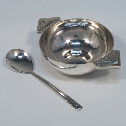 A beautiful Art Deco Sterling Silver christening set, consisting of a plain round bellied bowl with two cast side handles, and a plain spoon with matching hand-hammered decoration, all sitting in their original cream satin and black velvet-lined presentation box. This fantastic Art Deco silver bowl and spoon set was made by R. E. Stone of London in 1935. The dimensions of this fine hand-made silver christening set are length of spoon 14.5 cms (5.75 inches), diameter of bowl 11 cms (4.25 inches), and the total weight is approx. 226g (7.3 troy ounces).