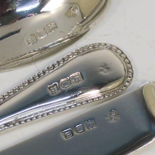 A pretty Antique Edwardian Sterling Silver christening set, having a knife, fork, and spoon, all with double-struck bead-edged pattern handles, and all sitting in their original dark blue satin and velvet-lined presentation box. This beautiful antique boxed christening set was made by Charles Boyton and Sons of London in 1907. The dimensions of this fine hand-made silver christening set are length of knife 19 cms (7.5 inches), with a total weight of approx. 122g (3.9 troy ounces).