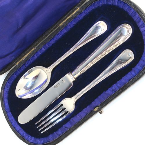 A pretty Antique Edwardian Sterling Silver christening set, having a knife, fork, and spoon, all with double-struck bead-edged pattern handles, and all sitting in their original dark blue satin and velvet-lined presentation box. This beautiful antique boxed christening set was made by Charles Boyton and Sons of London in 1907. The dimensions of this fine hand-made silver christening set are length of knife 19 cms (7.5 inches), with a total weight of approx. 122g (3.9 troy ounces).
