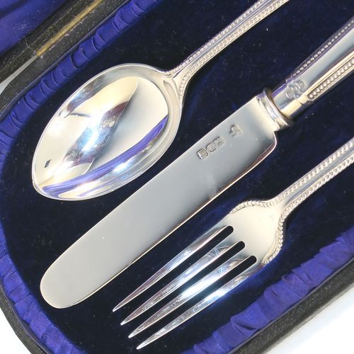 A pretty Antique Edwardian Sterling Silver christening set, having a knife, fork, and spoon, all with double-struck bead-edged pattern handles, and all sitting in their original dark blue satin and velvet-lined presentation box. This beautiful antique boxed christening set was made by Charles Boyton and Sons of London in 1907. The dimensions of this fine hand-made silver christening set are length of knife 19 cms (7.5 inches), with a total weight of approx. 122g (3.9 troy ounces).