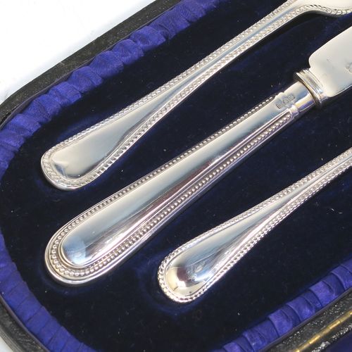 A pretty Antique Edwardian Sterling Silver christening set, having a knife, fork, and spoon, all with double-struck bead-edged pattern handles, and all sitting in their original dark blue satin and velvet-lined presentation box. This beautiful antique boxed christening set was made by Charles Boyton and Sons of London in 1907. The dimensions of this fine hand-made silver christening set are length of knife 19 cms (7.5 inches), with a total weight of approx. 122g (3.9 troy ounces).