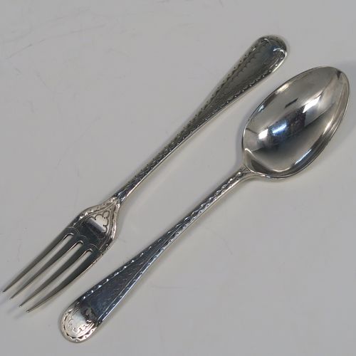 A very pretty Antique Sterling Silver christening set, having a fork and spoon in the Old English pattern, all hand-engraved on one side with a zig-zag border and stipple-work, and all sitting in their original dark blue satin and velvet-lined presentation box. This beautiful antique silver christening set was made by James Lewis and Sons of Sheffield in 1911. The dimensions of this fine hand-made antique silver christening set are length 14 cms (5.5 inches), with a total weight of approx. 47g (1.5 troy ounces)