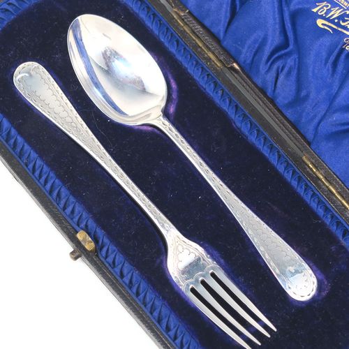 A very pretty Antique Sterling Silver christening set, having a fork and spoon in the Old English pattern, all hand-engraved on one side with a zig-zag border and stipple-work, and all sitting in their original dark blue satin and velvet-lined presentation box. This beautiful antique silver christening set was made by James Lewis and Sons of Sheffield in 1911. The dimensions of this fine hand-made antique silver christening set are length 14 cms (5.5 inches), with a total weight of approx. 47g (1.5 troy ounces)