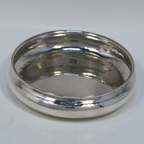 A beautiful Arts and Crafts style sterling Silver christening set, consisting of a round bellied bowl with hand-hammered decoration, and a plain spoon with a hand-pierced and applied ball handle, all sitting in their original cream satin and black velvet-lined presentation box. This fantastic Arts and Crafts silver bowl and spoon set was made by A. E. Jones of Birmingham in 1926/28. The dimensions of this fine hand-made silver christening set are length of spoon 13 cms (5 inches), diameter of bowl 13.5 cms (5.25 inches), and the total weight is approx. 178g (5.7 troy ounces).