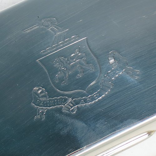 A Sterling Silver cigarette / cigar table box, having a plain rectangular body, with nice rounded corners, a hinged lid having an applied thumb-piece, and a gold-gilt and cedar wood-lined interior with two internal dividers. Made by Robert Comyns of London in 1932. The dimensions of this fine hand-made silver table box are length 19 cms (7.5 inches), width 9 cms (3.5 inches), and height 5.5 cms (2.25 inches). Please note that this item is crested.