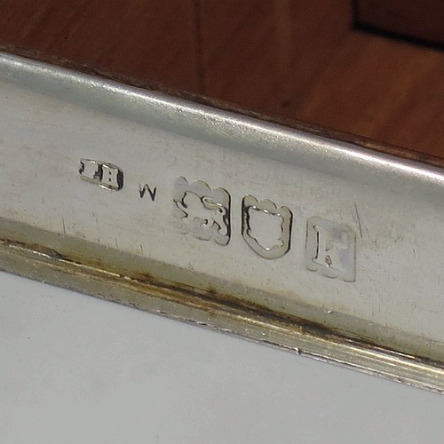 A handsome Antique Edwardian Sterling Silver cigarette / cigar table box, having a plain rectangular body with nice rounded corners, a hinged lid having an applied thumb-piece, and a cedar wood-lined interior to the base, with a removable divider. Made by Francis Higgins of London in 1905. The dimensions of this fine hand-made antique silver table cigar or cigarette box are length 13.5 cms (5.3 inches), width 9.5 cms (3.75 inches), and height 5.5 cms (2.25 inches).