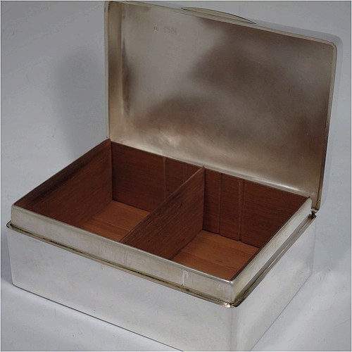 A handsome Antique Edwardian Sterling Silver cigarette / cigar table box, having a plain rectangular body with nice rounded corners, a hinged lid having an applied thumb-piece, and a cedar wood-lined interior to the base, with a removable divider. Made by Francis Higgins of London in 1905. The dimensions of this fine hand-made antique silver table cigar or cigarette box are length 13.5 cms (5.3 inches), width 9.5 cms (3.75 inches), and height 5.5 cms (2.25 inches).