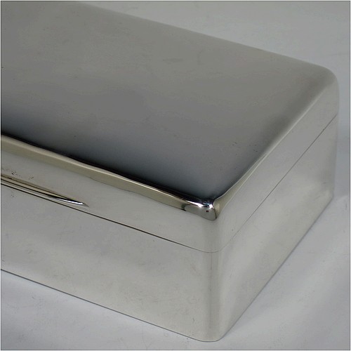 A handsome Antique Edwardian Sterling Silver cigarette / cigar table box, having a plain rectangular body with nice rounded corners, a hinged lid having an applied thumb-piece, and a cedar wood-lined interior to the base, with a removable divider. Made by Francis Higgins of London in 1905. The dimensions of this fine hand-made antique silver table cigar or cigarette box are length 13.5 cms (5.3 inches), width 9.5 cms (3.75 inches), and height 5.5 cms (2.25 inches).