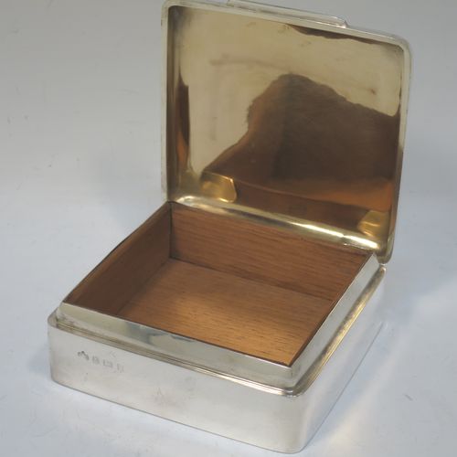 A handsome Antique Edwardian Sterling Silver cigarette / cigar table box, having a plain square body with nice rounded corners, a hinged lid with gold-gilt interior, an applied thumb-piece, and a cedar wood-lined interior to the base. Made by Elkington and Co., of Birmingham in 1907. The dimensions of this fine hand-made antique silver table cigar or cigarette box are 11 cms (4.25 inches) square and height 4 cms (1.5 inches).