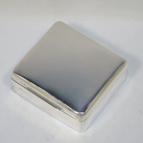 A handsome Antique Edwardian Sterling Silver cigarette / cigar table box, having a plain square body with nice rounded corners, a hinged lid with gold-gilt interior, an applied thumb-piece, and a cedar wood-lined interior to the base. Made by Elkington and Co., of Birmingham in 1907. The dimensions of this fine hand-made antique silver table cigar or cigarette box are 11 cms (4.25 inches) square and height 4 cms (1.5 inches).