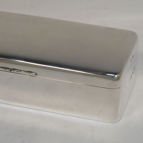 A very elegant Antique Victorian Sterling Silver cigarette / cigar table box, having a plain rectangular body with nice rounded corners, a hinged lid having an applied thumb-piece, a gold-gilt interior, and sitting on a flat base. This handsome antique silver cigar table box was made by A. & J. Zimmerman of Birmingham in 1898. The dimensions of this fine hand-made antique silver table cigar or cigarette box are length 21.5 cms (8.5 inches), width 9.5 cms (3.75 inches), height 6 cms (2.3 inches), and it weighs 640g (20.6 troy ounces). Please note that most old or antique cigar boxes are weighted in the base, and this one is not, so the whole weight is silver.