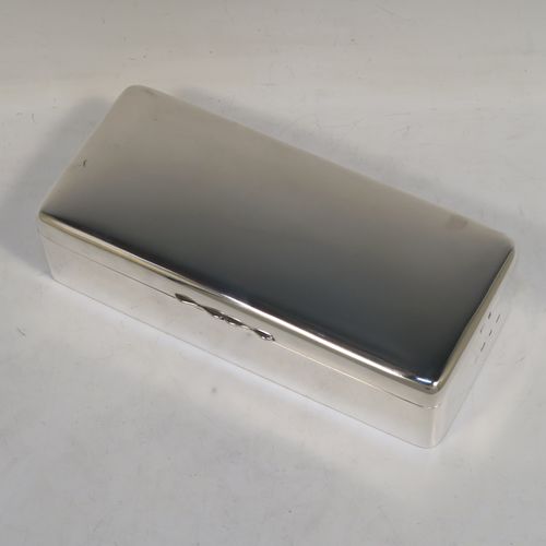 A very elegant Antique Victorian Sterling Silver cigarette / cigar table box, having a plain rectangular body with nice rounded corners, a hinged lid having an applied thumb-piece, a gold-gilt interior, and sitting on a flat base. This handsome antique silver cigar table box was made by A. & J. Zimmerman of Birmingham in 1898. The dimensions of this fine hand-made antique silver table cigar or cigarette box are length 21.5 cms (8.5 inches), width 9.5 cms (3.75 inches), height 6 cms (2.3 inches), and it weighs 640g (20.6 troy ounces). Please note that most old or antique cigar boxes are weighted in the base, and this one is not, so the whole weight is silver.