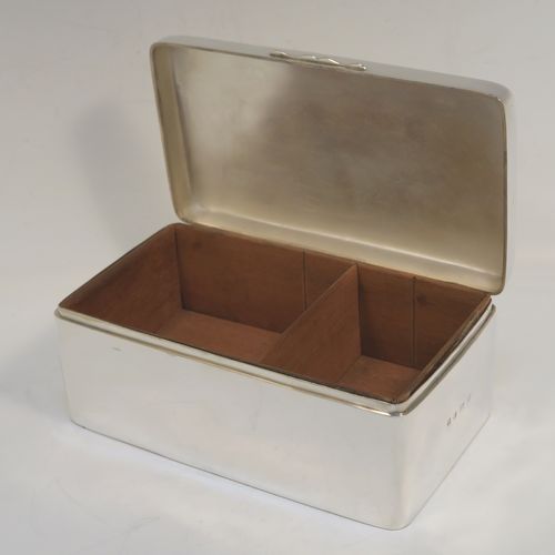 A very handsome Antique Edwardian Sterling Silver cigarette or cigar table box, having a plain rectangular body with nice rounded corners, a hinged lid having an applied thumb-piece, with a cedar wood-lined interior to the base and a removable divider. This elegant antique silver table box was made by A. and J. Zimmerman of Birmingham in 1903. The dimensions of this fine hand-made antique silver table cigar or cigarette box are length 17 cms (6.75 inches), depth 10 cms (4 inches), and height 7 cms (2.75 inches).
