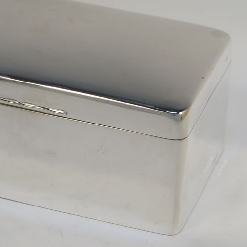A very elegant Antique Sterling Silver cigarette or cigar table box, having a plain rectangular body with nice rounded corners, a hinged lid having an applied thumb-piece, with a cedar wood-lined interior to the base and a removable divider. This elegant antique silver table box was made by A. and J. Zimmerman of Birmingham in 1913. The dimensions of this fine hand-made antique silver table cigar or cigarette box are length 17 cms (6.75 inches), depth 10 cms (4 inches), and height 7 cms (2.75 inches).