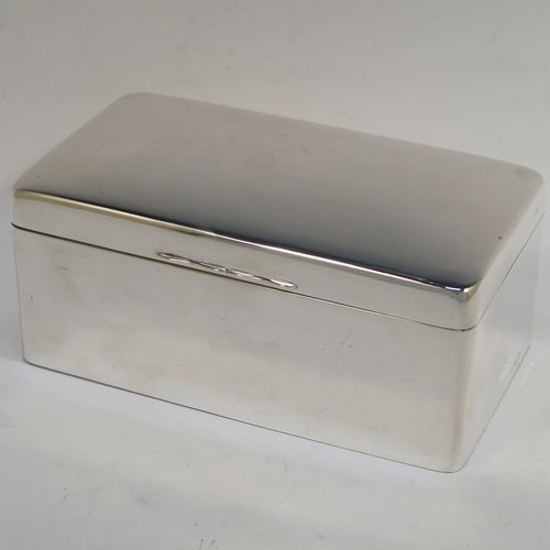 A very elegant Antique Sterling Silver cigarette or cigar table box, having a plain rectangular body with nice rounded corners, a hinged lid having an applied thumb-piece, with a cedar wood-lined interior to the base and a removable divider. This elegant antique silver table box was made by A. and J. Zimmerman of Birmingham in 1913. The dimensions of this fine hand-made antique silver table cigar or cigarette box are length 17 cms (6.75 inches), depth 10 cms (4 inches), and height 7 cms (2.75 inches).