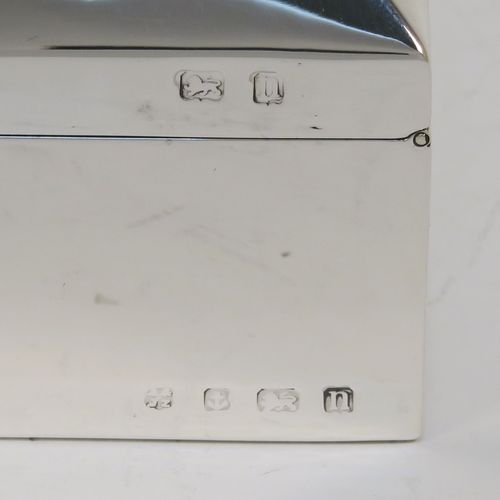 A very elegant Antique Sterling Silver cigarette / cigar table box, having a plain rectangular body, a hinged lid having an applied thumb-piece and chamfered edges, with a gold-gilt and cedar wood-lined interior to the base. This handsome antique silver table box was made by A. and J. Zimmerman of Birmingham in 1912. The dimensions of this fine hand-made antique silver table cigar or cigarette box are length 13.5 cms (5.3 inches), width 10 cms (4 inches), and height 5.5 cms (2.25 inches).