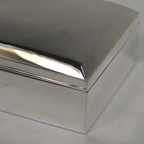A very elegant Antique Sterling Silver cigarette / cigar table box, having a plain rectangular body, a hinged lid having an applied thumb-piece and chamfered edges, with a gold-gilt and cedar wood-lined interior to the base. This handsome antique silver table box was made by A. and J. Zimmerman of Birmingham in 1912. The dimensions of this fine hand-made antique silver table cigar or cigarette box are length 13.5 cms (5.3 inches), width 10 cms (4 inches), and height 5.5 cms (2.25 inches).