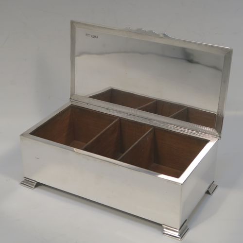 A very elegant Sterling Silver Art Deco style cigarette / cigar table box, having a very plain rectangular body with straight sides, a hinged lid with engine-turned decoration, a central vacant cartouche and thumb-piece, a wooden cedar-lined interior with two dividers, and all sitting on four stepped corner feet. This handsome silver table box was made by Mappin & Webb of London in 1947. The dimensions of this fine hand-made Art Deco silver table box are length 18 cms (7 inches), height 6 cms (2.5 inches), and width 9.5 cms (3.75 inches).