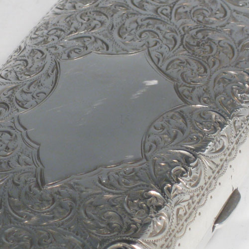 Antique Edwardian sterling silver cigar case, having a rectangular shaped body with rounded corners, hand-engraved floral decoration, central vacant cartouche, and thumb-piece with catch. Made by the Robinson Brothers of Birmingham in 1902. Length 13 cms (5 inches), width 6 cms (2.3 inches), depth 2.5 cms (1 inch). Weight approx. 115g (3.7 troy ounces).