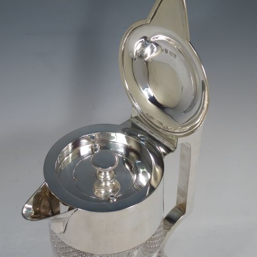 A very handsome and large Antique Victorian Sterling Silver and hand-cut crystal lemonade or pimms jug, having a plain round mount, a hinged lid with a pierced thumb-piece, a plain square cross-section handle, a sparrow-beak style spout, together with an original internal glass tube for crushed ice (with silver handle and bayonet-fit lift-off lid), a hand-cut crystal body with lobes of hobnail-cut decoration, and all sitting on a flat star-cut base. Made by Streeter and Co. Ltd., of London in 1899. The dimensions of this fine hand-made antique silver and crystal pimms or lemonade jug are height 28 cms (11 inches), length 21 cms (8.25 inches), and diameter at base 17 cms (6.75 inches).