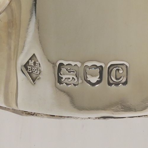 A very handsome Antique Victorian Sterling Silver and hand-cut crystal claret jug in an Arts and Crafts style, having a plain round mount, a flat hinged lid, a plain geometrical straight handle with lower strengthening ring, together with a hand-cut round and panelled crystal body with lower hobnail cut and star-cut base. This beautiful silver and crystal claret jug was made by the Mappin Brothers of London in 1898. The dimensions of this fine hand-made antique silver and crystal claret jug are height 22 cms (8.75 inches), and length 14 cms (5.5 inches).  
