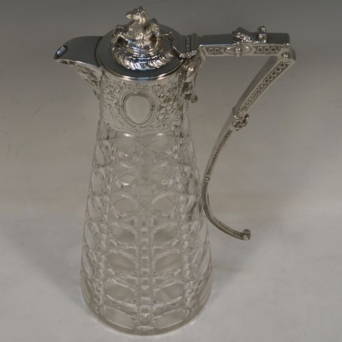 A very pretty Antique Victorian Silver Plated and hand-cut crystal claret jug, having a hand-chased mount with floral decoration and Bacchus face on the spout, a cast Pegasus finial, a scrolled cast handle, and a crystal body with hobnail cut. This beautiful antique silver-plated claret jug was made in ca. 1880. The dimensions of this fine hand-made silver-plated claret jug are height 29 cms (11.5 inches), length 16 cms (6.3 inches).