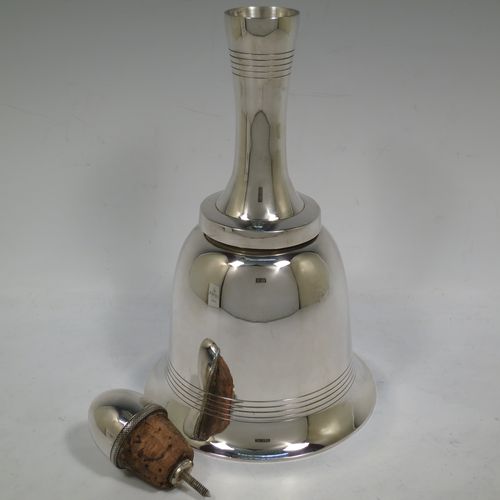 A very unusual novelty Silver-Plated cocktail shaker in the shape of a table bell, having a plain round body with hand-engraved reeded decoration, with a screw-off hollow handle attached to the main body, and a screw-off terminal lid with cork seal covering a pouring strainer section. Made by Edward and Sons of Glasgow, Scotland, in ca. 1930. The dimensions of this fine hand-made silver plated table bell cocktail shaker are height 28 cms (11 inches), diameter at base 15 cms (6 inches).