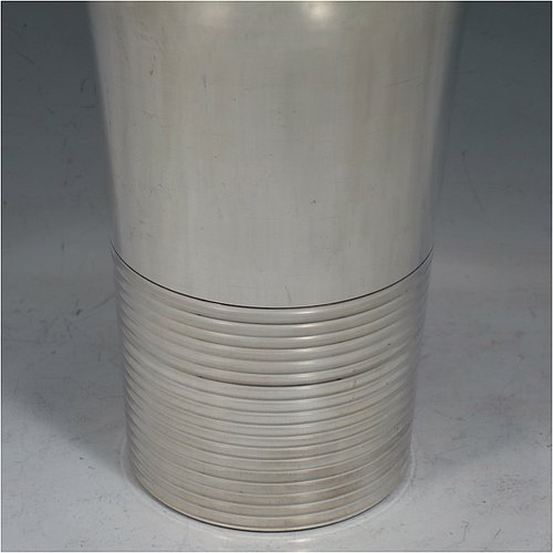 A very handsome Art Deco style Silver-Plated cocktail shaker, having a plain round body with tapering sides, with a pull-off lid and a strainer section, together with a lower band of hand-chased reeded decoration. Made in ca. 1930. The dimensions of this fine hand-made silver plated cocktail shaker are height 21 cms (8.25 inches), diameter at widest point 10 cms (4 inches).