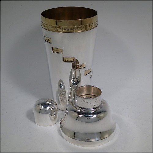A rare and unusual Silver-Plated Art Deco mechanical menu cocktail shaker, having a plain round body with tapering sides, with a pull-off lid and strainer section, with an internal revolving gold-plated menu system showing various cocktails on the upper menu and then all the required constituents in small staggered windows down the body. Made in ca. 1930. The dimensions of this fine hand-made silver plated menu cocktail shaker are height 27 cms (10.75 inches), diameter at widest point 10 cms (4 inches).