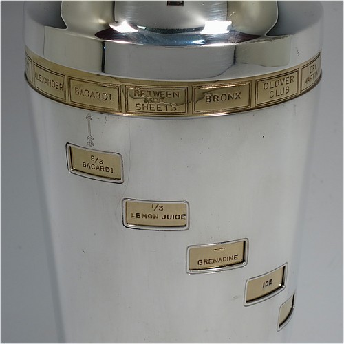 A rare and unusual Silver-Plated Art Deco mechanical menu cocktail shaker, having a plain round body with tapering sides, with a pull-off lid and strainer section, with an internal revolving gold-plated menu system showing various cocktails on the upper menu and then all the required constituents in small staggered windows down the body. Made in ca. 1930. The dimensions of this fine hand-made silver plated menu cocktail shaker are height 27 cms (10.75 inches), diameter at widest point 10 cms (4 inches).