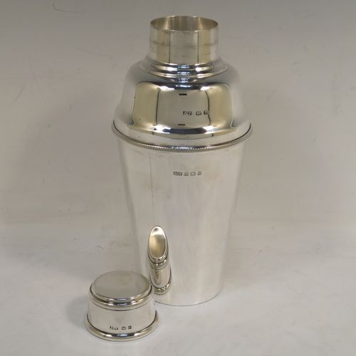 A very handsome Sterling Silver Art Deco cocktail shaker, having a plain round body with tapering sides, with a pull-off lid and interior strainer section, and an applied knurled edge to the main body. This elegant silver cocktail shaker was made by J. C. Vickery of Birmingham in 1929. The dimensions of this fine hand-made silver cocktail shaker are height 20 cms (8 inches), diameter at widest point 9 cms (3.5 inches), and it weighs approx. 340g (11 troy ounces).  