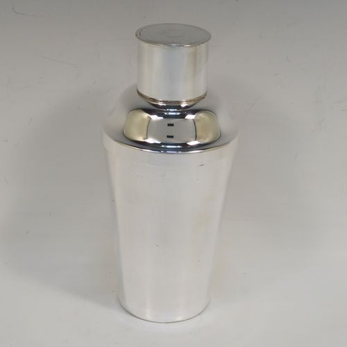 A very handsome Art Deco style Silver-Plated cocktail shaker, having a plain round body with tapering sides, with a pull-off lid and a strainer section. This elegant silver-plated cocktail shaker was made in ca. 1930. The dimensions of this fine hand-made silver plated cocktail shaker are height 18 cms (7 inches), diameter at widest point 8.5 cms (3.3 inches).   