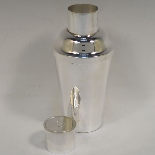 A very handsome Art Deco style Silver-Plated cocktail shaker, having a plain round body with tapering sides, with a pull-off lid and a strainer section. This elegant silver-plated cocktail shaker was made in ca. 1930. The dimensions of this fine hand-made silver plated cocktail shaker are height 18 cms (7 inches), diameter at widest point 8.5 cms (3.3 inches).