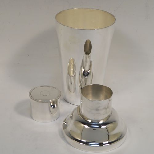 A very handsome Art Deco style Silver-Plated cocktail shaker, having a plain round body with tapering sides, with a pull-off lid and a strainer section. This elegant silver-plated cocktail shaker was made in ca. 1930. The dimensions of this fine hand-made silver plated cocktail shaker are height 18 cms (7 inches), diameter at widest point 8.5 cms (3.3 inches).