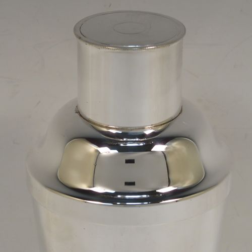 A very handsome Art Deco style Silver-Plated cocktail shaker, having a plain round body with tapering sides, with a pull-off lid and a strainer section. This elegant silver-plated cocktail shaker was made in ca. 1930. The dimensions of this fine hand-made silver plated cocktail shaker are height 18 cms (7 inches), diameter at widest point 8.5 cms (3.3 inches).