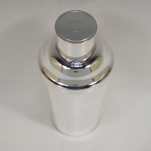 A very handsome Art Deco style Silver-Plated cocktail shaker, having a plain round body with tapering sides, with a pull-off lid and a strainer section. This elegant silver-plated cocktail shaker was made in ca. 1930. The dimensions of this fine hand-made silver plated cocktail shaker are height 18 cms (7 inches), diameter at widest point 8.5 cms (3.3 inches).