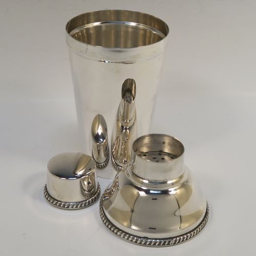A very handsome Italian 800 Standard Silver Art Deco cocktail shaker, having a plain round body with tapering sides, with a pull-off lid and interior strainer section, with applied gadroon borders to the pull-off parts. This elegant silver cocktail shaker was made Miracoli of Italy in ca. 1960. The dimensions of this fine hand-made silver cocktail shaker are height 20 cms (8 inches), diameter at widest point 9 cms (3.5 inches), and it weighs approx. 380g (12.3 troy ounces).  