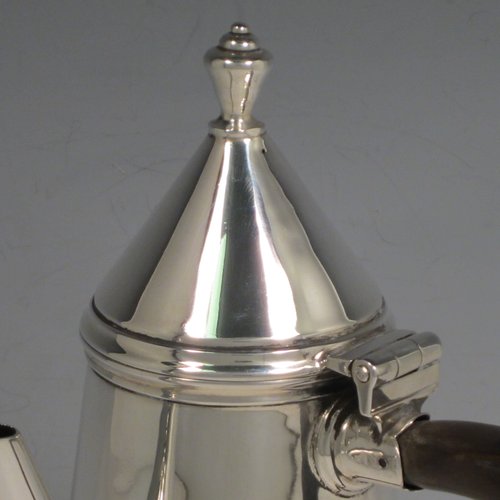 Antique Sterling silver fine hand-made William & Mary style coffee pot, having a very plain round body with tapering sides, a conical hinged lid with finial, a straight spout, and a wooden looped side-handle, all sitting on a raised base. Made by Thomas Bradbury & Sons of London in 1911. The dimensions of this fine silver coffee pot are length 12 cms (4.75 inches), height 22 cms (8.5 inches), and it weighs approx. 400g (13 troy ounces).   