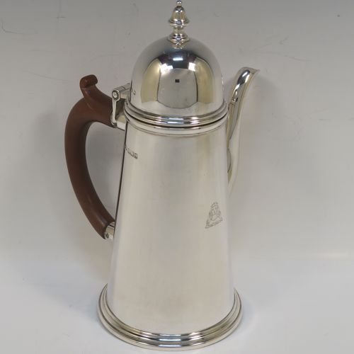 A very handsome Antique Sterling Silver George I style side-handled coffee pot, having a plain round body with straight tapering sides, a hinged domed lid with cast urn-shaped finial, a curved spout, a hand-carved brown-stained wooden scroll handle, and all sitting on a collet foot. This elegant silver coffee-pot was made by P and F of Sheffield in 1917. The dimensions of this fine hand-made antique silver side-handled coffee pot are length 12.5 cms (5 inches), height 21.5 cms (8.5 inches), and it weighs approx. 465g (15 troy ounces).