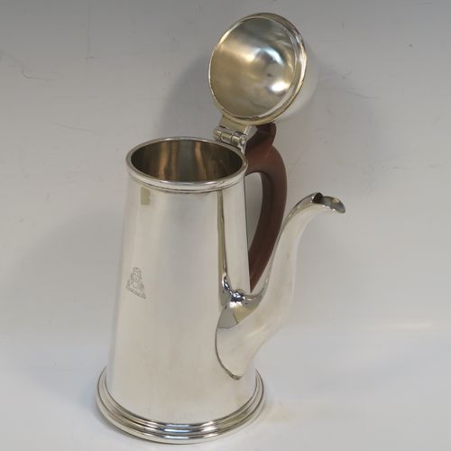 A very handsome Antique Sterling Silver George I style side-handled coffee pot, having a plain round body with straight tapering sides, a hinged domed lid with cast urn-shaped finial, a curved spout, a hand-carved brown-stained wooden scroll handle, and all sitting on a collet foot. This elegant silver coffee-pot was made by P and F of Sheffield in 1917. The dimensions of this fine hand-made antique silver side-handled coffee pot are length 12.5 cms (5 inches), height 21.5 cms (8.5 inches), and it weighs approx. 465g (15 troy ounces).