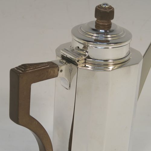 A very elegant Art Deco style Sterling Silver bachelor size coffee pot, having a straight-sided panelled body, a brown wooden side-handle with stepped thumb-piece, a stepped hinged lid with wooden finial, a straight panelled spout, and all sitting on a collet foot. This beautiful silver Art Deco coffee pot was made by Charles S. Green & Co. Ltd., of Birmingham in 1933. This Art Deco coffee pot would be suitable for serving two people and the dimensions of this fine hand-made silver coffee pot are length 16 cms (6.25 inches), height 16.5 cms (6.5 inches), and it weighs approx. 280g (9 troy ounces).  