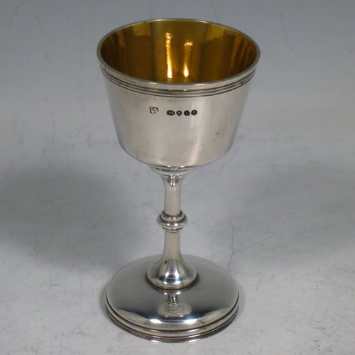 An Antique Victorian sterling silver three-piece travelling communion set consisting of chalice, paten, and wine bottle. The chalice having a round body with reeded borders, a gold-gilt interior, and sitting on a pedestal foot. The paten having a round body with a reeded border, and sitting on a collet foot. The wine bottle having a plain round screw-off lid, an original glass stopper, and the glass body with hand-cut panelled decoration. All three are engraved with a Christogram, and all sit in their original blue velvet-lined presentation box. Made by Charles Rawlings & William Summers of London in 1860. The dimensions of this fine hand-made silver travelling communion set are height of chalice 8 cms (3.25 inches), diameter of paten 6.8 cms (2.6 inches), and with a total weight of approx. 82g (2.6 troy ounces).    