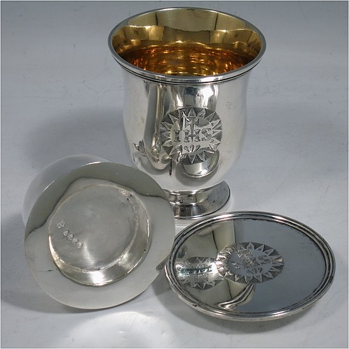 A rare Antique Georgian (William IV) Sterling Silver travelling communion set in the shape of a bell, consisting of a chalice, paten, and silver bottle with stopper. The chalice having a round body with reeded borders, and a gold-gilt interior. The bottle having the same style, but slightly smaller to fit inside the goblet when collapsed, and a pull-off stopper with loop handle. The paten having a round body with a reeded border, and sitting on a collet foot. All three are engraved with a Christogram. Made by Reily and Storer of London in 1830. The dimensions of this fine hand-made antique silver travelling communion set are height (when attached together) 7.5 cms (3 inches), diameter of paten 6.5 cms (2.5 inches), and with a total weight of approx. 192g (6.2 troy ounces).   
